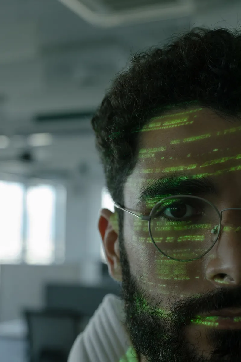 Visage éclairé par du code numérique
